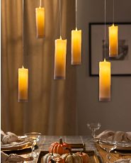 Hanging artificial candles over dining table