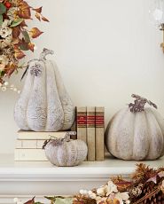 Set of white wooden pumpkins on mantel