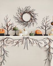 Mantel with Halloween twig foliage and artificial pumpkins