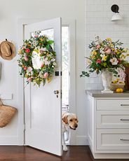 White back door in the kitchen with a dog going through