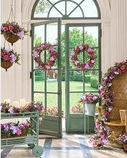 Green front door and window decorated with lavender and pink artificial floral garland, wreath, window box, hanging planter, and potted arrangement