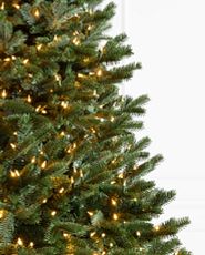 Closeup of artificial Christmas tree with clear LED lights