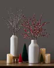 Artificial berry branches and twigs in vase