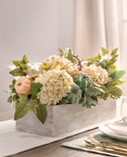 Artificial flower arrangement with hydrangeas and pumpkins