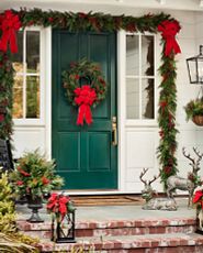 Front door Christmas décor idea with a wreath and garlands